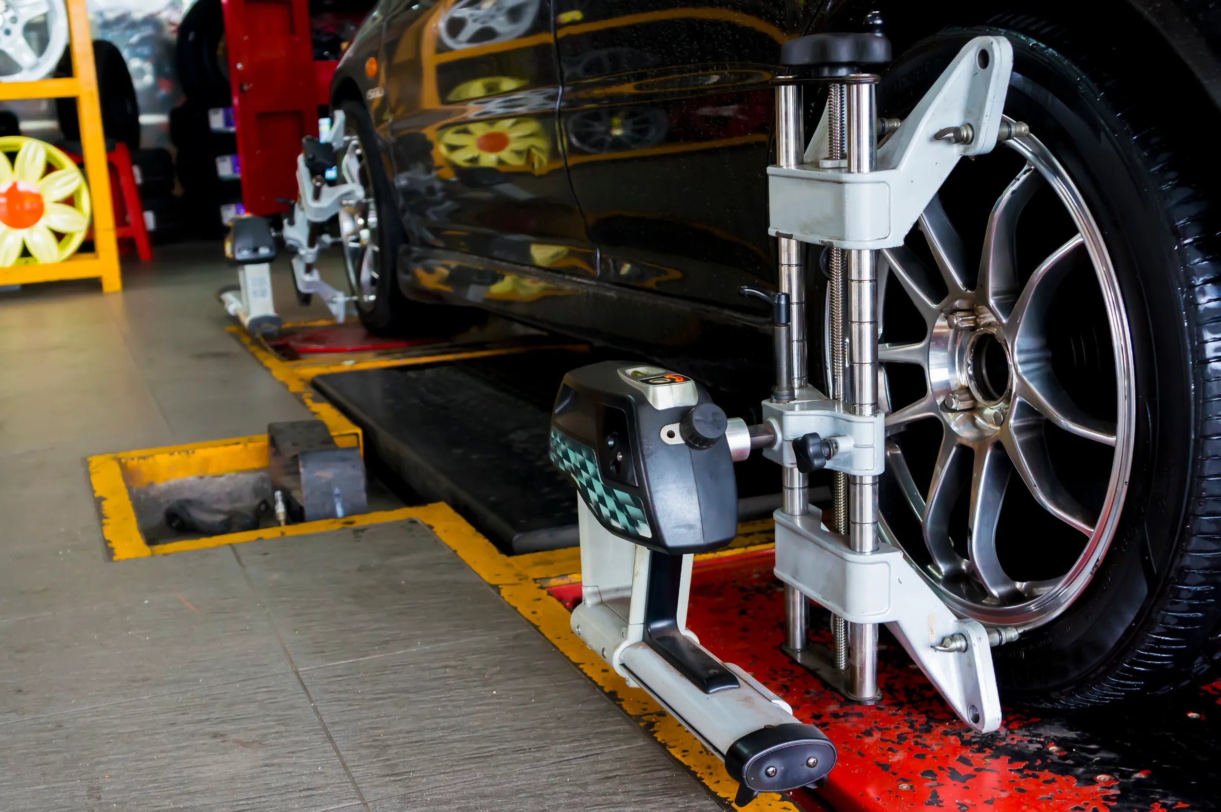Industrial tire changer and digital wheel balancer set in a professional automotive workshop